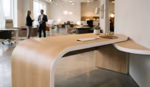 A high-end light oak office desk featuring a complex S-curve and straight edges, finished with seamless white edge banding using a multi functional edge banding machine.