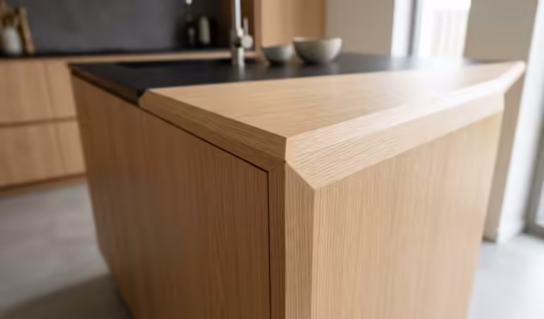 Luxury handleless oak kitchen cabinet with precision 45 degree edge banding, showcasing the high-end output of a professional bevel edge banding machine.
